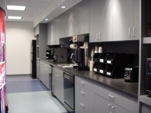 Office break room with soda vending machine and refrigerator.