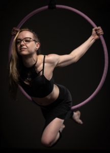 Female doing acrobatic dance with a ring